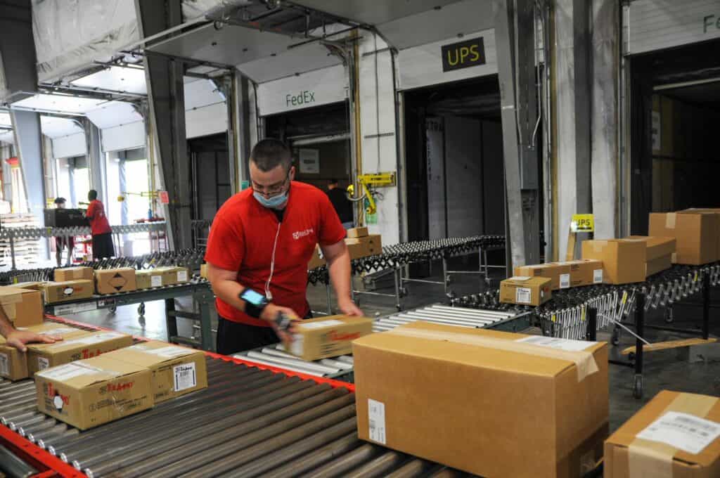 Loading packages when carriers arrive during the COVID/holiday peak season.