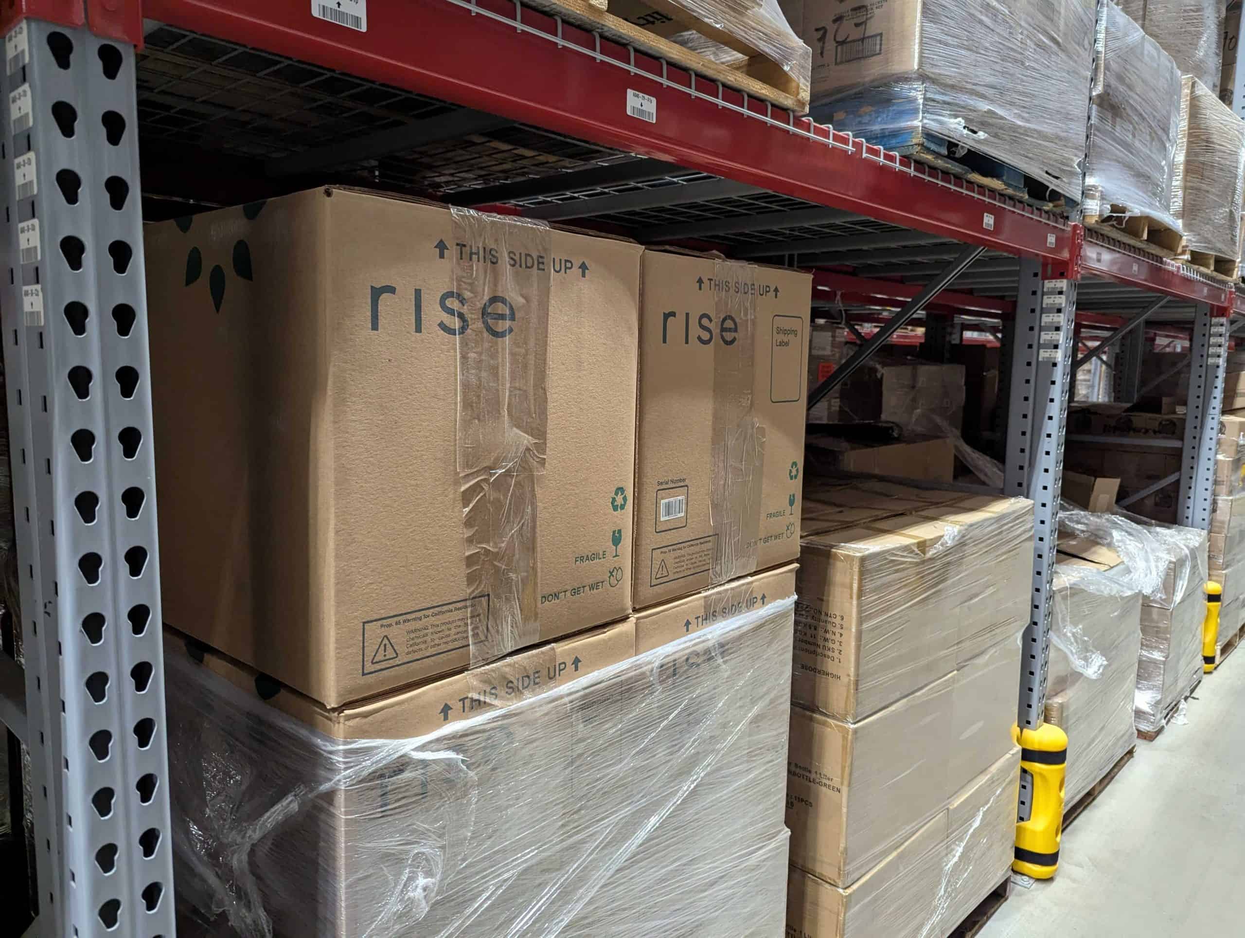 Large packages in shrink wrap on a wooden pallet.