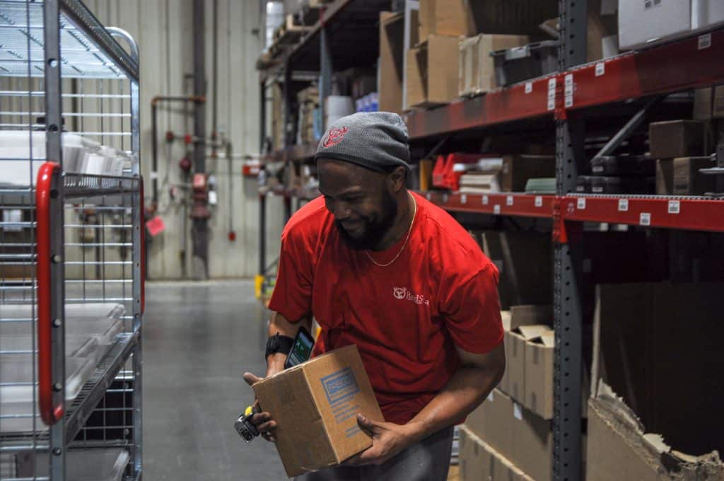 Workers at a Red Stag Fulfillment center