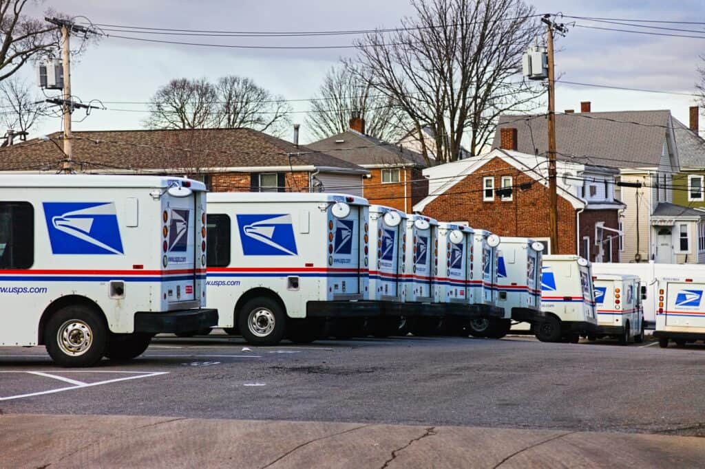a fleet of USPS trucks ready